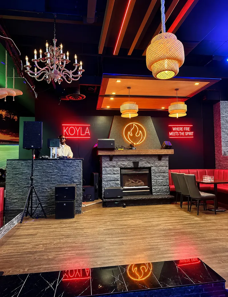 Stone fireplace with the neon sign: Where fire meets the spirit