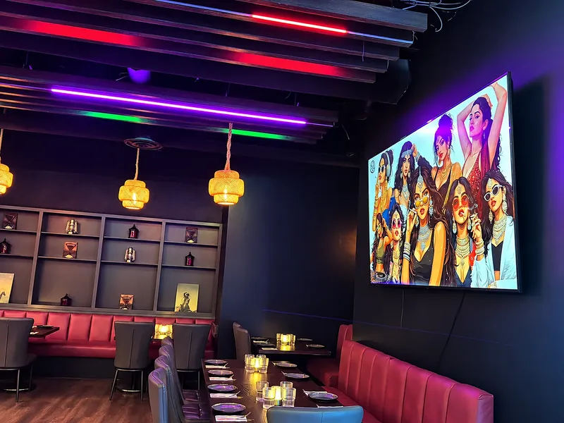 Big screen showing a game beside the lounge seating